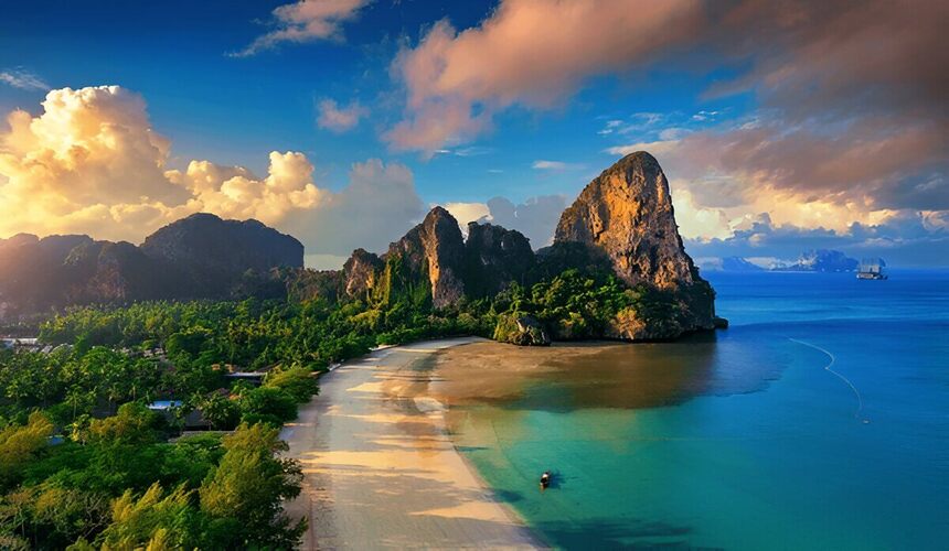 Longtail boats anchored on white sand at Railay Beach, Krabi, Thailand