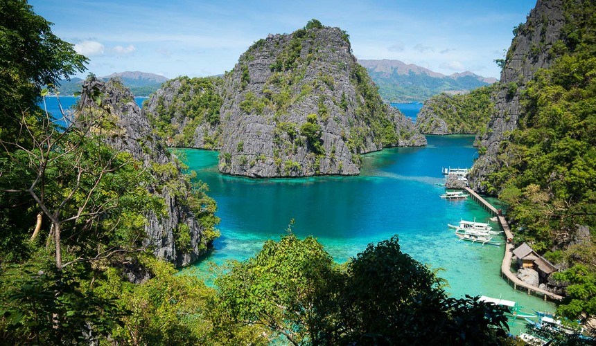 Aerial view of turquoise lagoons and karst cliffs in Coron Philippines