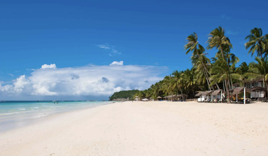 Tourists relaxing on White Beach Boracay Philippines with turquoise sea